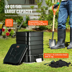 Black 5-tray HDPE worm composter bin with expandable capacity up to 50L, shown outdoors with a person adding soil.