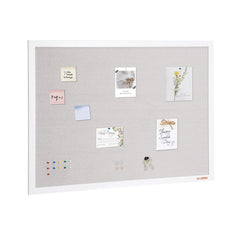 White-framed 48x36 inch linen bulletin board with pinned notes, photos, and accessories.
