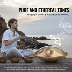A man sits by the sea playing a 22-inch gold handpan drum with 10 notes using a mallet, surrounded by singing bowls.