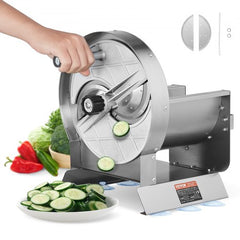 A hand using a stainless steel manual vegetable slicer to cut cucumbers into thin slices on a counter.