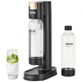Black Bostome sparkling water maker with gold accents, two clear 1L bottles, and a glass of lime water.