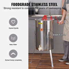 Stainless steel manual honey extractor with hand crank, stand, and frame holder.