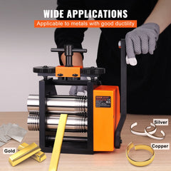 A person operates an orange and black jewelry rolling mill with gold, silver, and copper samples.