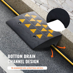 Black rubber curb ramp with yellow triangular grips, 6-inch rise, and bottom drainage channels.