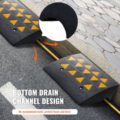 Two black rubber curb ramps with yellow diamond patterns and drainage channels for protecting hoses and wires.