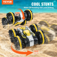 A yellow and black amphibious RC car performing a 180-degree flip and a 360-degree spin on sand.
