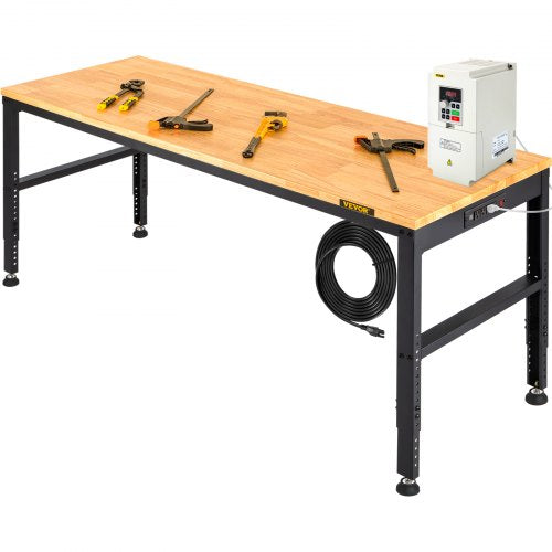 A long, light wood workbench with black adjustable legs holds various tools and a power inverter.