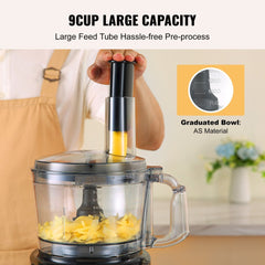 Black 9-cup food processor with 600W motor chopping carrots in a clear bowl, shown with large feed tube.