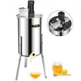 Stainless steel electric honey extractor with three-frame capacity and adjustable legs.