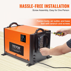 Orange VEVOR dehumidifier with screw assembly, easy one-person installation using wrench and screwdriver.