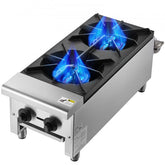 Two-burner stainless steel commercial gas range stove with blue flames and control knobs.