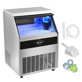 Stainless steel commercial ice maker with 88lbs storage bin full of ice, scoop, and accessories.