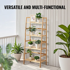 A 4-tier natural bamboo ladder bookshelf in trapezoid shape, displayed on a balcony with potted plants.