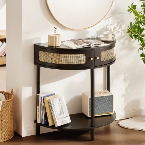 Black half-moon rattan console table with two drawers and an open shelf for storage.
