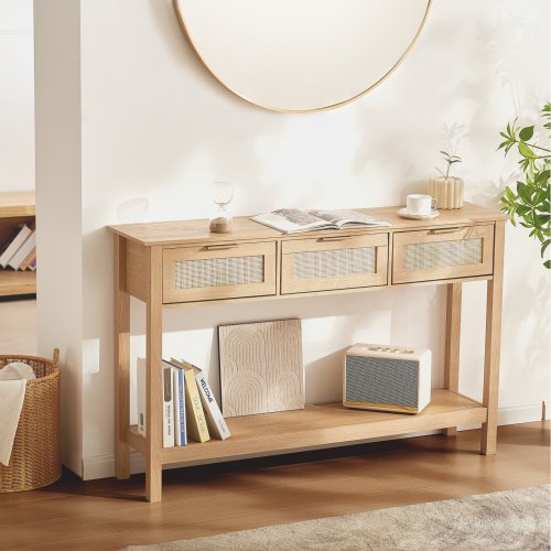 Natural wood console table with three drawers and a sliding door, featuring rattan accents.