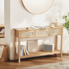 Natural wood console table with three drawers and a sliding door, featuring rattan accents.