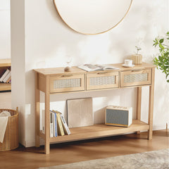 Natural wood console table with three drawers and a sliding door, featuring rattan accents.