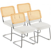 Set of four mid-century modern rattan dining chairs with white velvet seats and chrome legs.