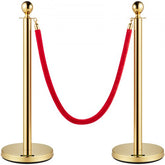 Gold stanchion posts with red velvet rope for crowd control, featuring durable construction.