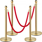 Gold stanchions with red velvet ropes, designed for crowd control and elegant event management.