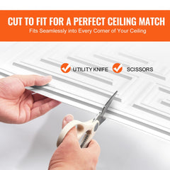 Hands cutting white PVC ceiling tile with echo pattern using scissors.