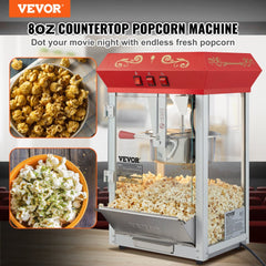 Red 8 oz countertop popcorn machine with stainless steel kettle, warming deck, and glass walls.