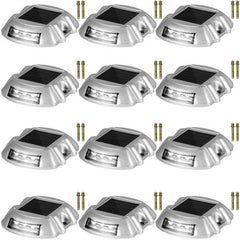 12-pack of silver solar driveway lights with white LED panels and mounting screws.