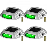 Four waterproof green 6-LED solar driveway lights in a pack.