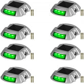 Eight green LED solar driveway lights with a waterproof design for outdoor use.