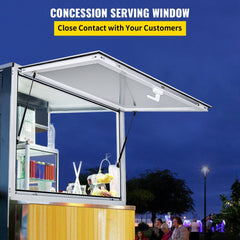 Aluminum concession serving window with pneumatic lift and secure handle lock open at night.