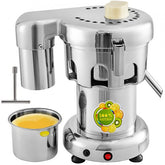 Stainless steel commercial centrifugal juice extractor with pulp container and fresh orange juice.