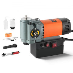 Lightweight 1300W low-profile magnetic drill press with orange motor, gray base, and accessories.