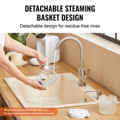 A woman rinses the detachable steaming basket of a baby food maker under a kitchen faucet.