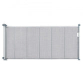 Gray retractable baby gate with wide mesh design, extending up to 76.8 inches for safety.
