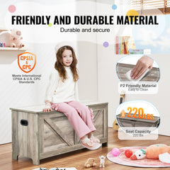 Gray wooden toy chest storage bench for kids with a child sitting on it, showing durable material and 220 lb seat capacity.