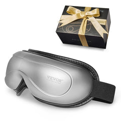 Silver VEVOR heated eye massager with 5 modes and Bluetooth, shown folded and in black gift box with gold ribbon.