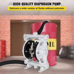White polypropylene double diaphragm pump connected by black hose to red oil drum in garage.