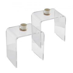 Clear acrylic C-shaped end tables with smooth edges and stable design for versatile use.