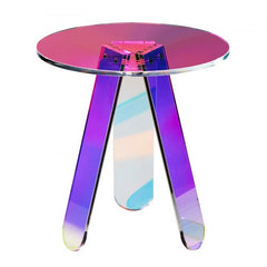 Round iridescent acrylic side table with clear rainbow top and three angled legs.