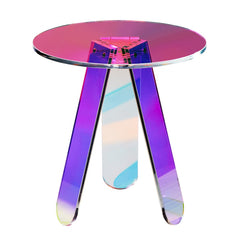 Round iridescent acrylic side table with clear rainbow top and three legs.