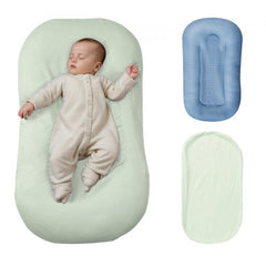 Infant lounger with sleeping newborn in green cotton cover, plus blue cover and spare green one.