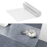 Transparent PVC cat carpet protector, 15" x 4', shown rolled and unrolled with studs, protecting doorway rug from gray cat.