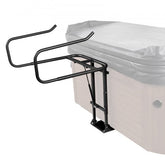 Black hydraulic hot tub cover lift with adjustable arms mounted on a beige spa.