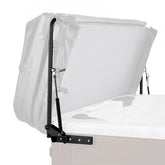 Black hydraulic hot tub cover lift with adjustable arms holding open a white rectangular spa cover.