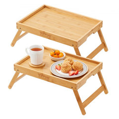 Two bamboo bed tray tables with foldable design and sturdy legs for versatile use.