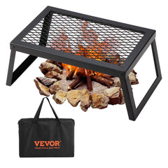 Black steel folding campfire grill with mesh grate over rocks and flames, including carrying bag.
