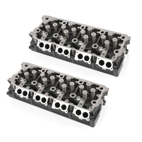 Pair of cast-iron cylinder heads for 6.4L Powerstroke engine, fully assembled with valves and springs.