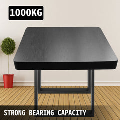 A black square wooden table with black metal legs and 1000kg capacity in a modern room.