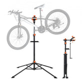 A black and orange heavy-duty bike repair stand holds a bicycle, with a folded stand beside it.