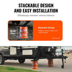 Two orange polypropylene RV leveling blocks stacked to 13.7 inches high, supporting a trailer on uneven ground.